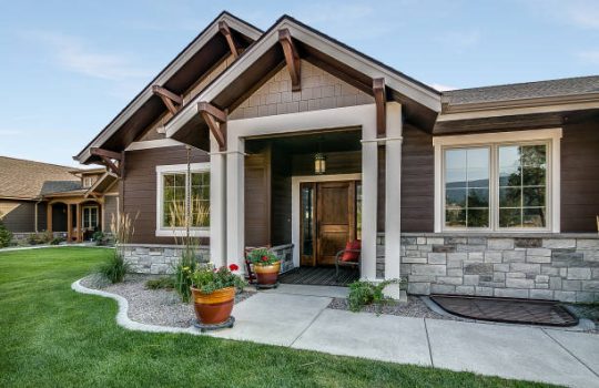 Nice contrast of brown house and green grass